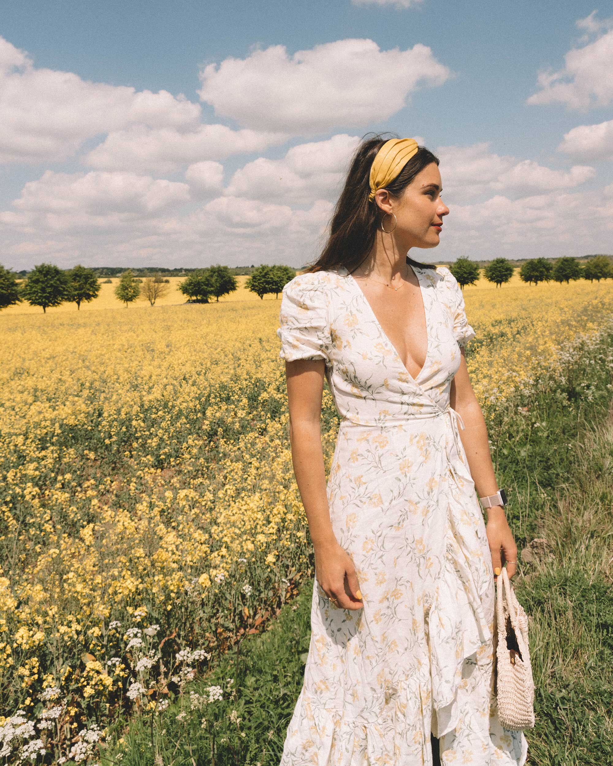 Sarah+Butler+of+Sarah+Styles+Seattle+wears+And+Other+Stories+Ruffled+Linen+Wrap+Midi+Dress+and+round+woven+bag+in+England+Countryside+for+the+perfect+floral+summer+dress+|+@sarahchristine+3.jpg