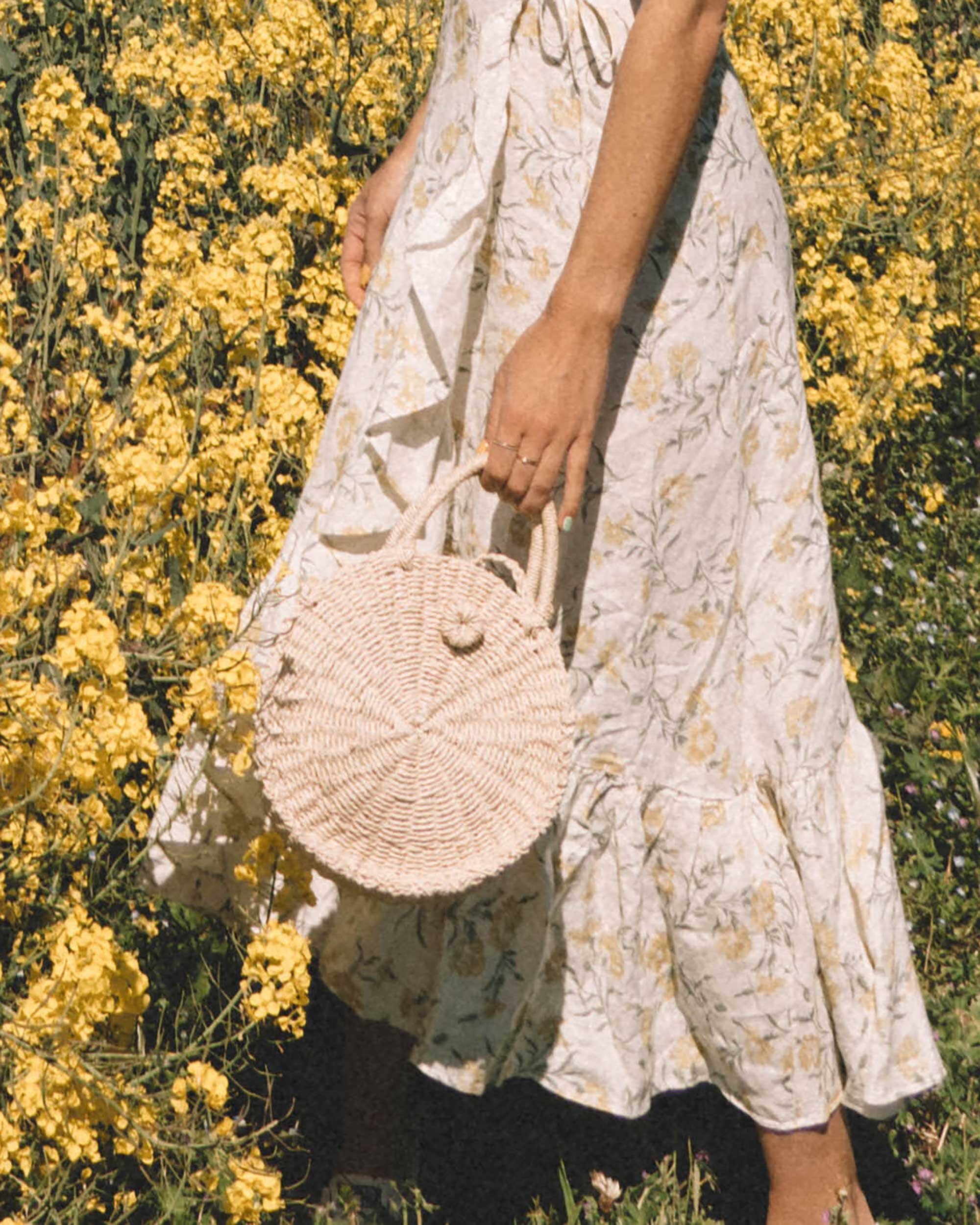 Sarah+Butler+of+Sarah+Styles+Seattle+wears+And+Other+Stories+Ruffled+Linen+Wrap+Midi+Dress+and+round+woven+bag+in+England+Countryside+for+the+perfect+floral+summer+dress+|+@sarahchristine+-3-2.jpg