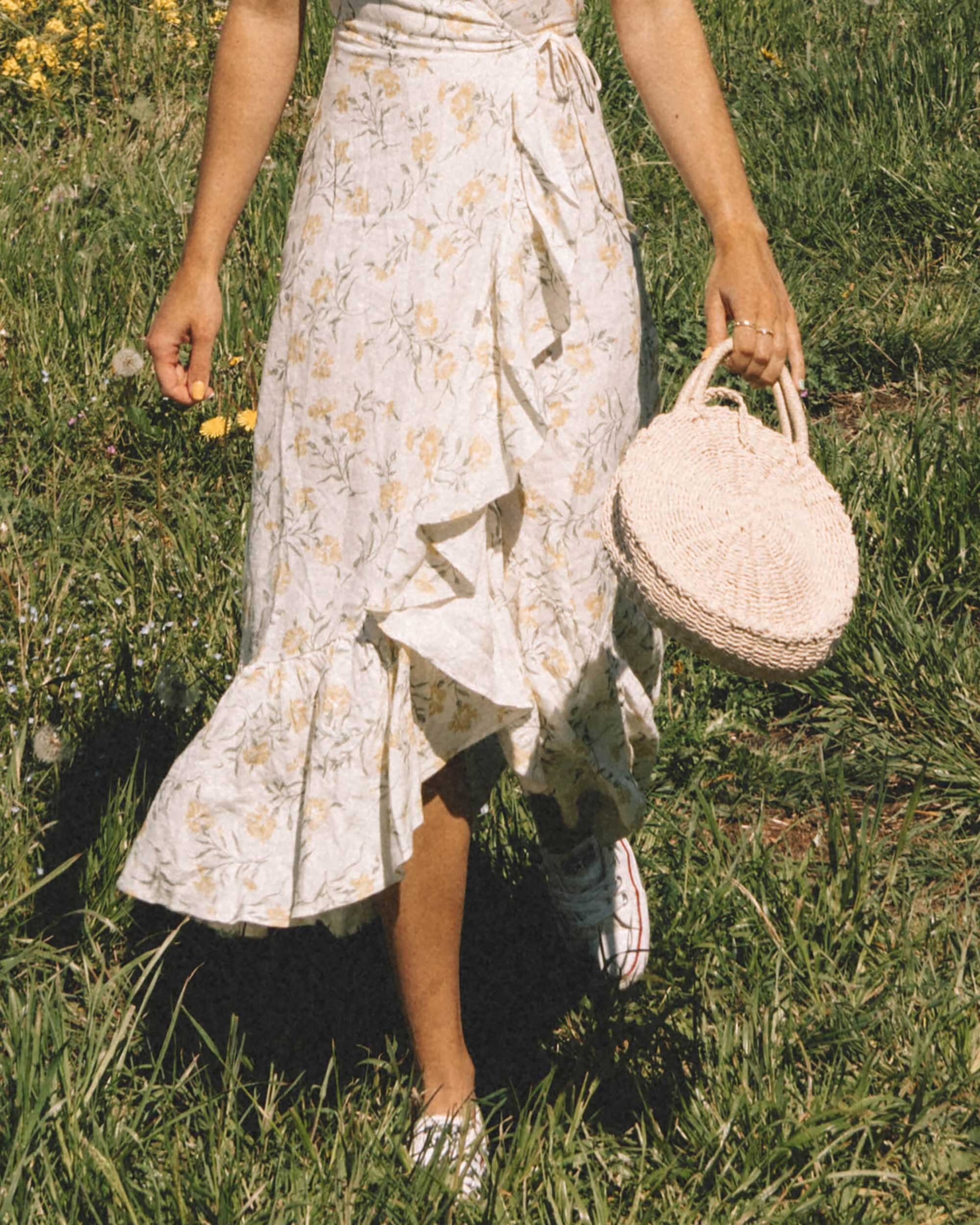 Sarah+Butler+of+Sarah+Styles+Seattle+wears+And+Other+Stories+Ruffled+Linen+Wrap+Midi+Dress+and+round+woven+bag+in+England+Countryside+for+the+perfect+floral+summer+dress+|+@sarahchristine+-1.jpg