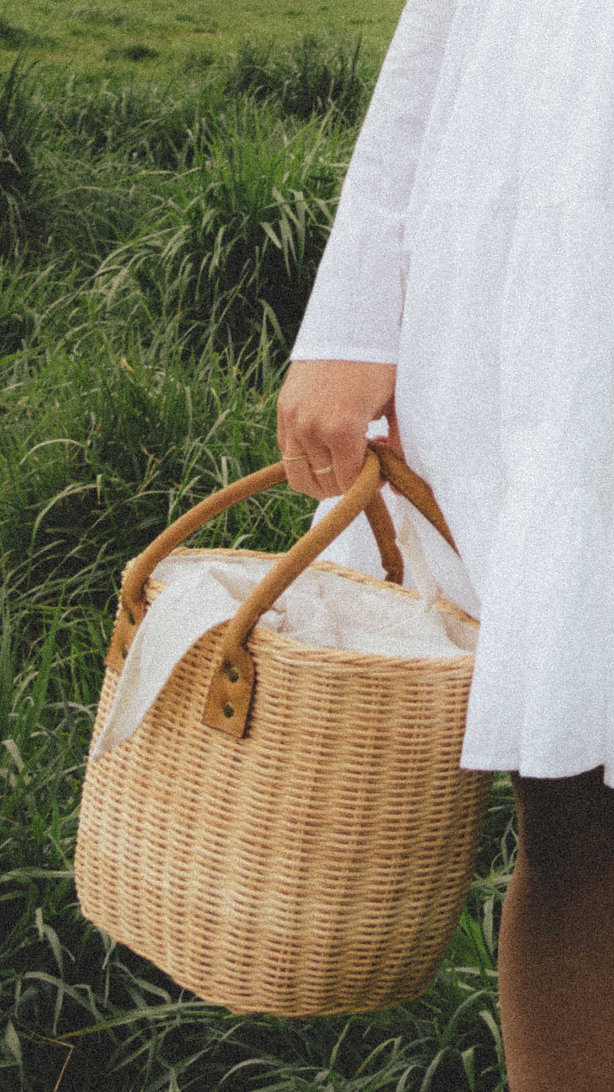 Cute white summer mini dress. Sarah Butler of @sarahchristine wearing Merlette Soliman Tiered White Mini Dress with basket bag in countryside of Seattle, Washington - 3.jpg