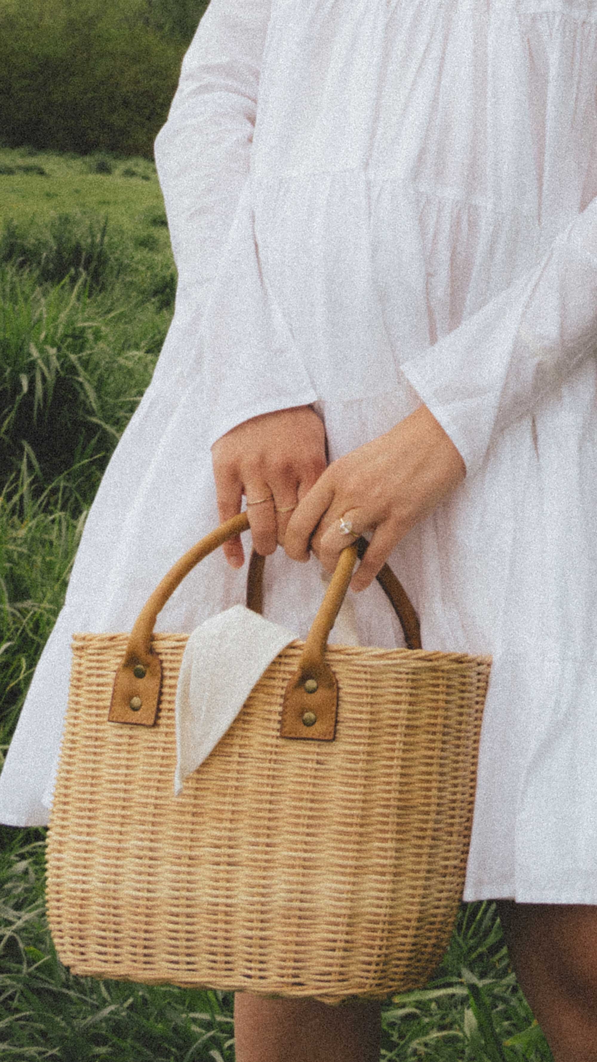 Cute white summer mini dress. Sarah Butler of @sarahchristine wearing Merlette Soliman Tiered White Mini Dress with basket bag in countryside of Seattle, Washington - 5.jpg