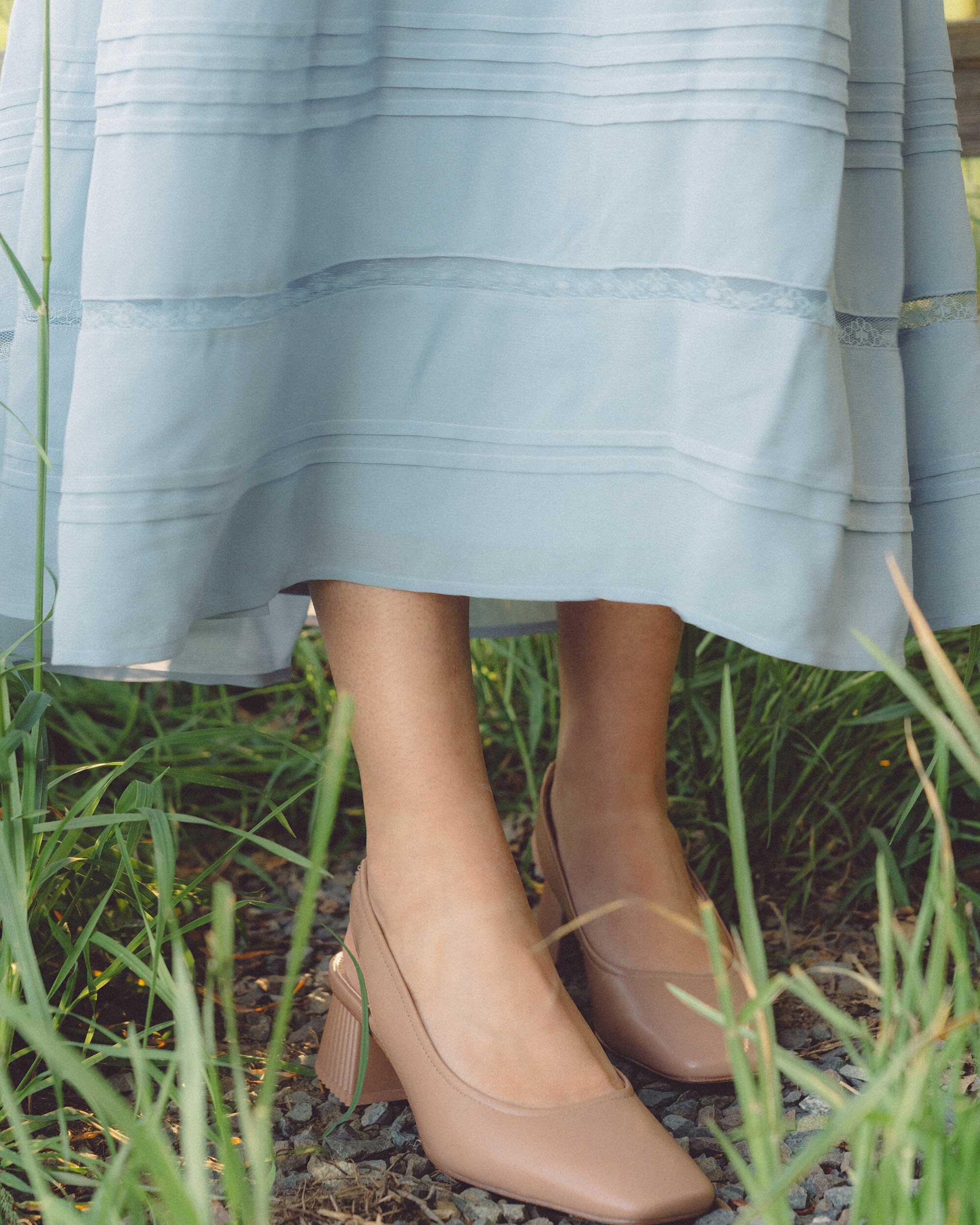 Cute cottage style summer dress. Sarah Butler of @sarahchristine wearing Reformation Jessy Blue Long Sleeve Smocked Dress with lace detailing and Sam Edelman Toren Square Toe Block Heel in countryside field of Seattle, Washington - 5.jpg