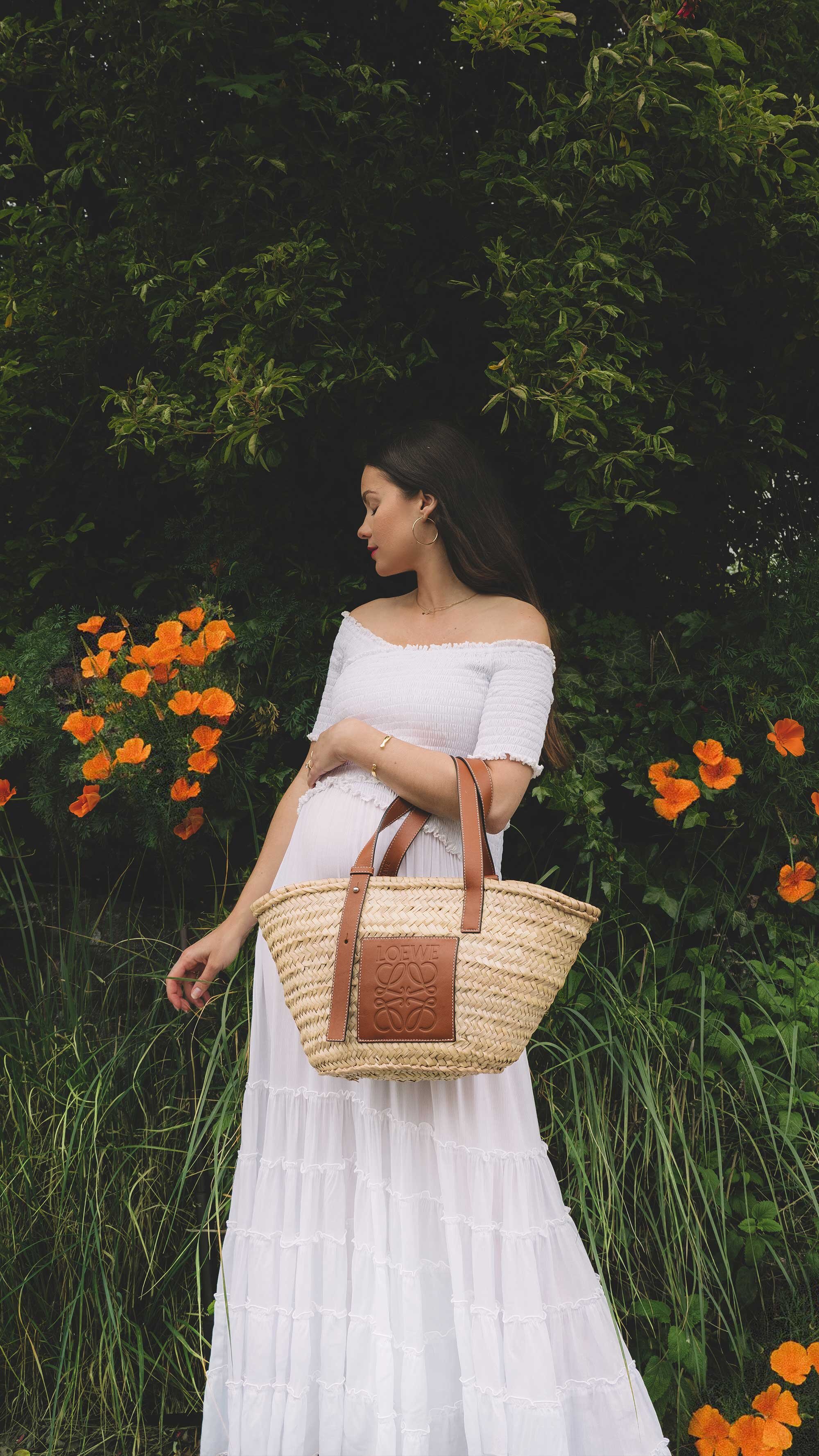 Cute cottage style summer dress. Sarah Butler of @sarahchristine wearing Poupette St Barth Soledad Off-shoulder White Midi Dress and Loewe Leather-Trimmed Woven Basket Bag in countryside field of Seattle, Washington -3.jpg