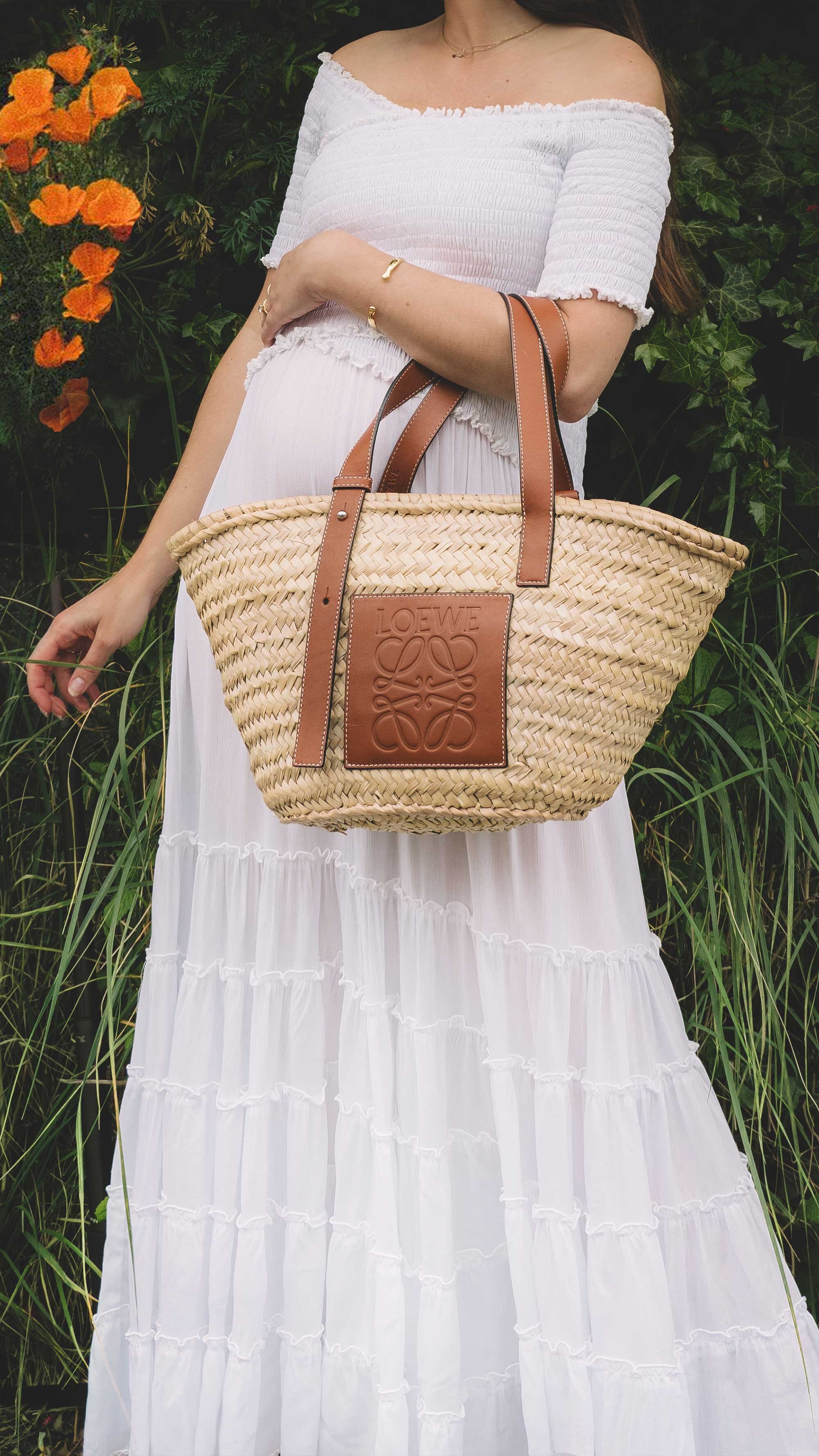Cute cottage style summer dress. Sarah Butler of @sarahchristine wearing Poupette St Barth Soledad Off-shoulder White Midi Dress and Loewe Leather-Trimmed Woven Basket Bag in countryside field of Seattle, Washington -5.jpg