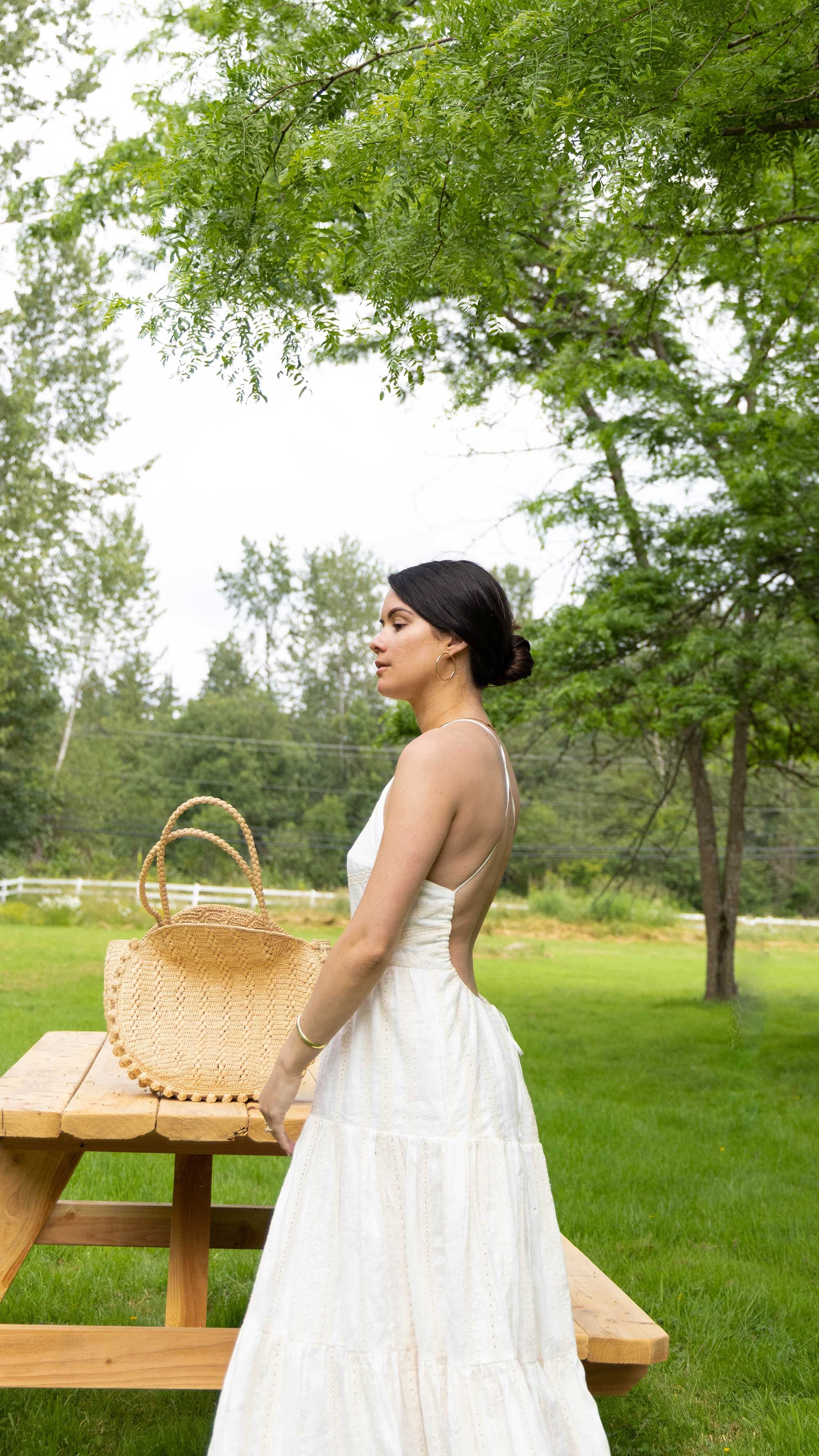 Feminine summer outfit idea: IVORY LINEN BACKLESS HALTER MIDI DRESS. Sarah Butler of @sarahchristine wearing Shona Joy halter tiered midi dress with back cut out detail in a linen broderie englaise in Seattle, Washington.1.jpg