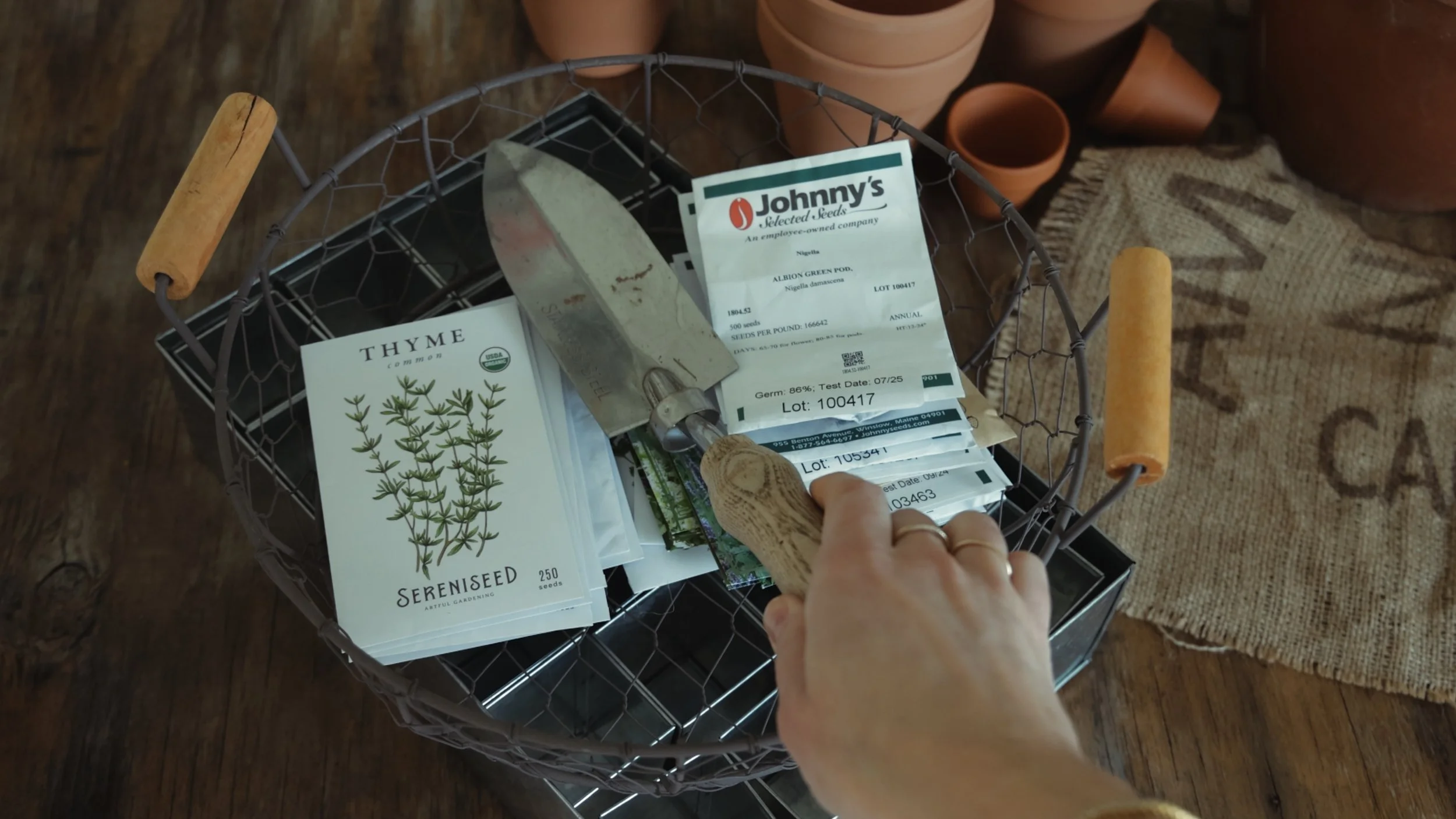 Seed starting supplies on a wooden table for February flower farm planning
