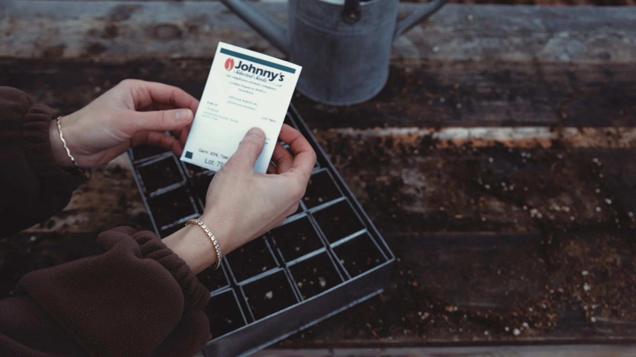 Filling seed trays with soil for early spring flowers.