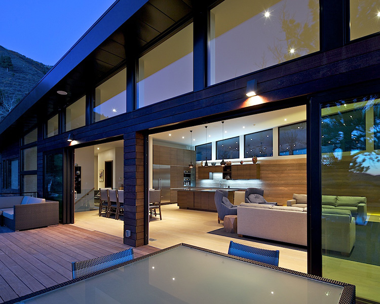 Large glass panels are removed to allow for seamless movement onto the back deck for entertaining. 