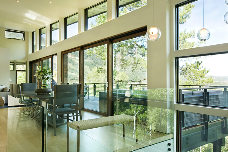  Beautiful large living room with walls of windows for natural light and endless views with clean simple furnishings. 