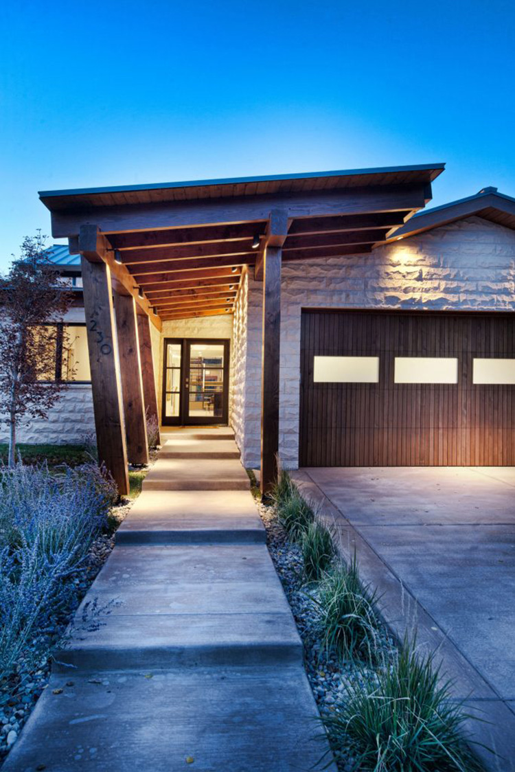  This slopped roof line makes the entryway feel wider as it leads to the deep set door 