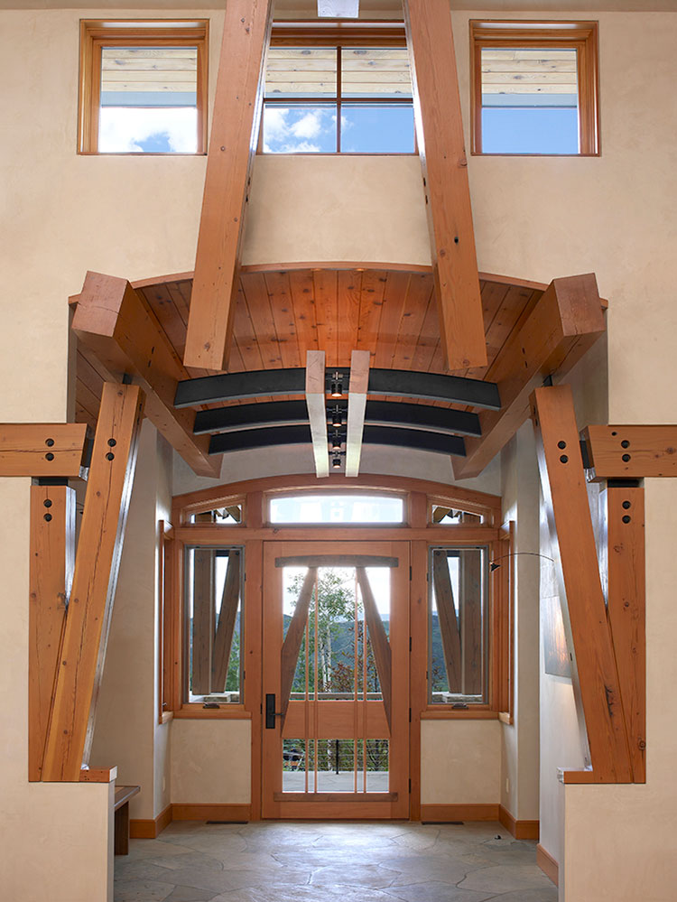  Arched entryway to this grand Snowmass Village home with large wood beams and soaring ceilings 