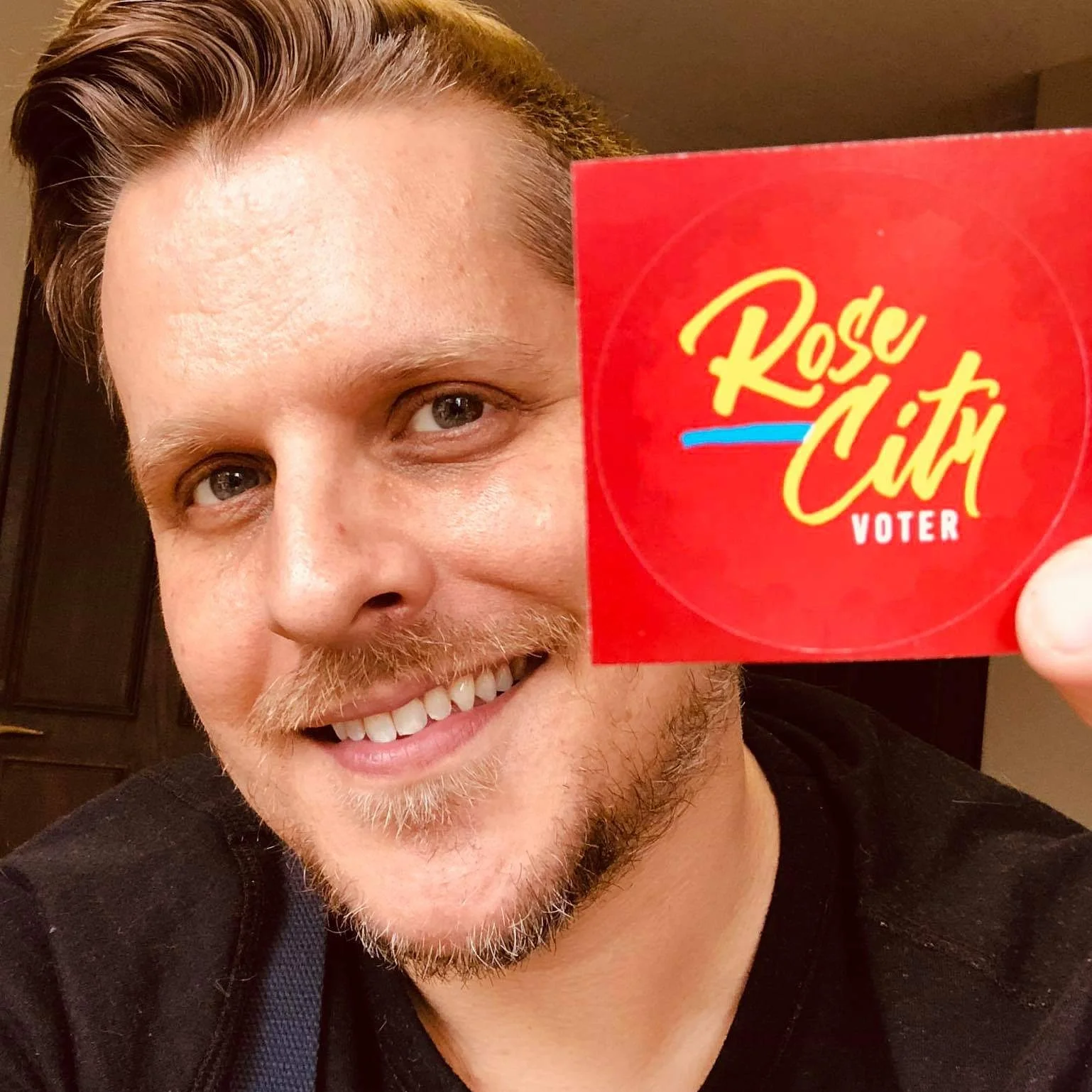 93 .9 The River’s Dan Macdonald showing his support for Ballots & Brews with one of the custom voter stickers.