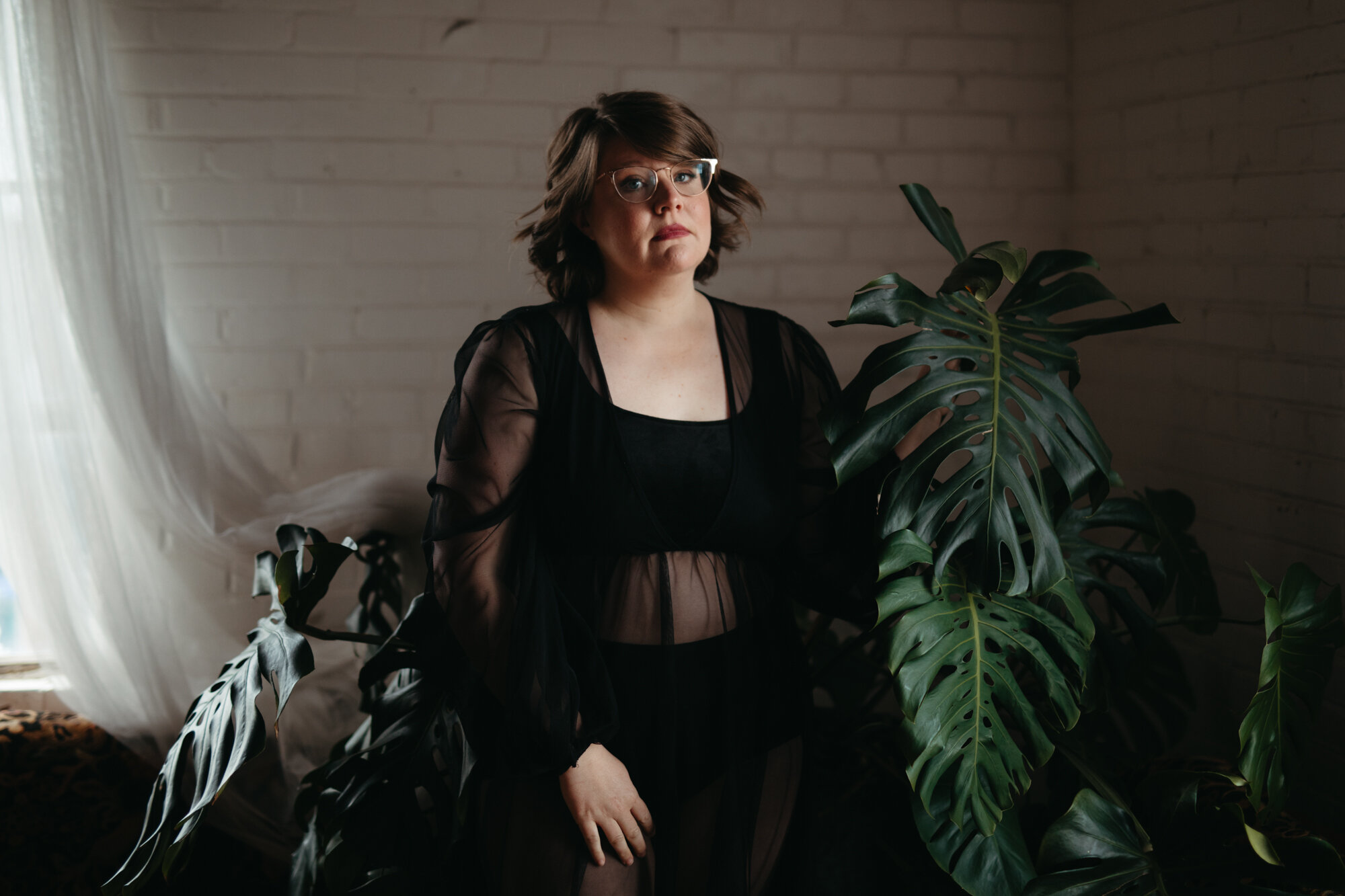 Asexual boudoir portrait of agender person in black robe