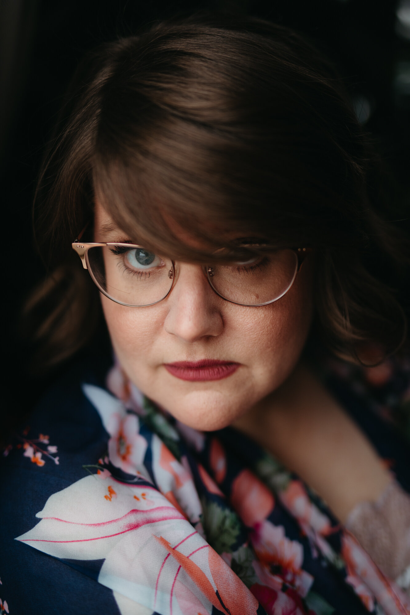 Asexual boudoir portrait of person with glasses