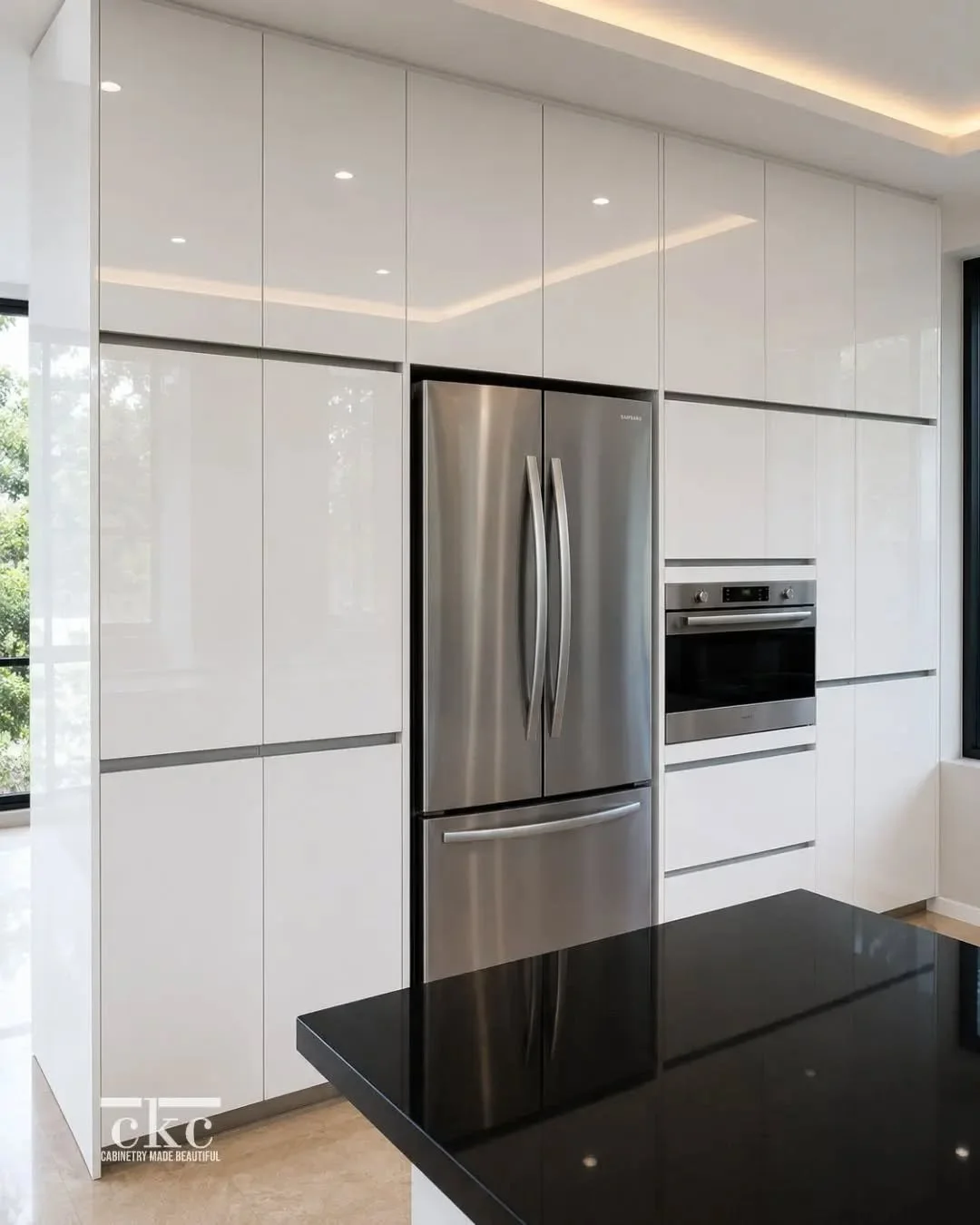 ✨ Clean lines, timeless finishes, and thoughtful details.

This custom kitchen features high-gloss cabinetry, glass display cabinets with integrated lighting, built-in appliances, and sleek black countertops&mdash;designed to be as functional as it i