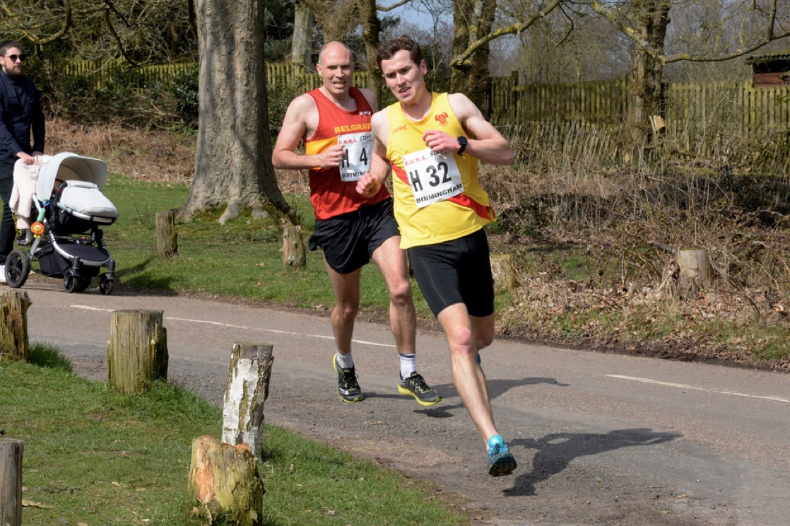 Andrew Penney eases ahead of Belgrave's Will Cockerell to clock the team's fastest short leg time at the 12-stage National Road Relay Championships at Sutton Park, Birmingham