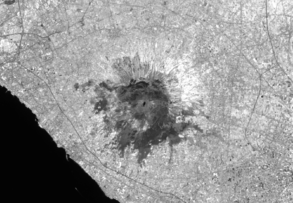 A GIF animation showing modified satellite images of Mount Vesuvius pre- and post-fire. The burn scars are quite visible (in dark) after the fire.