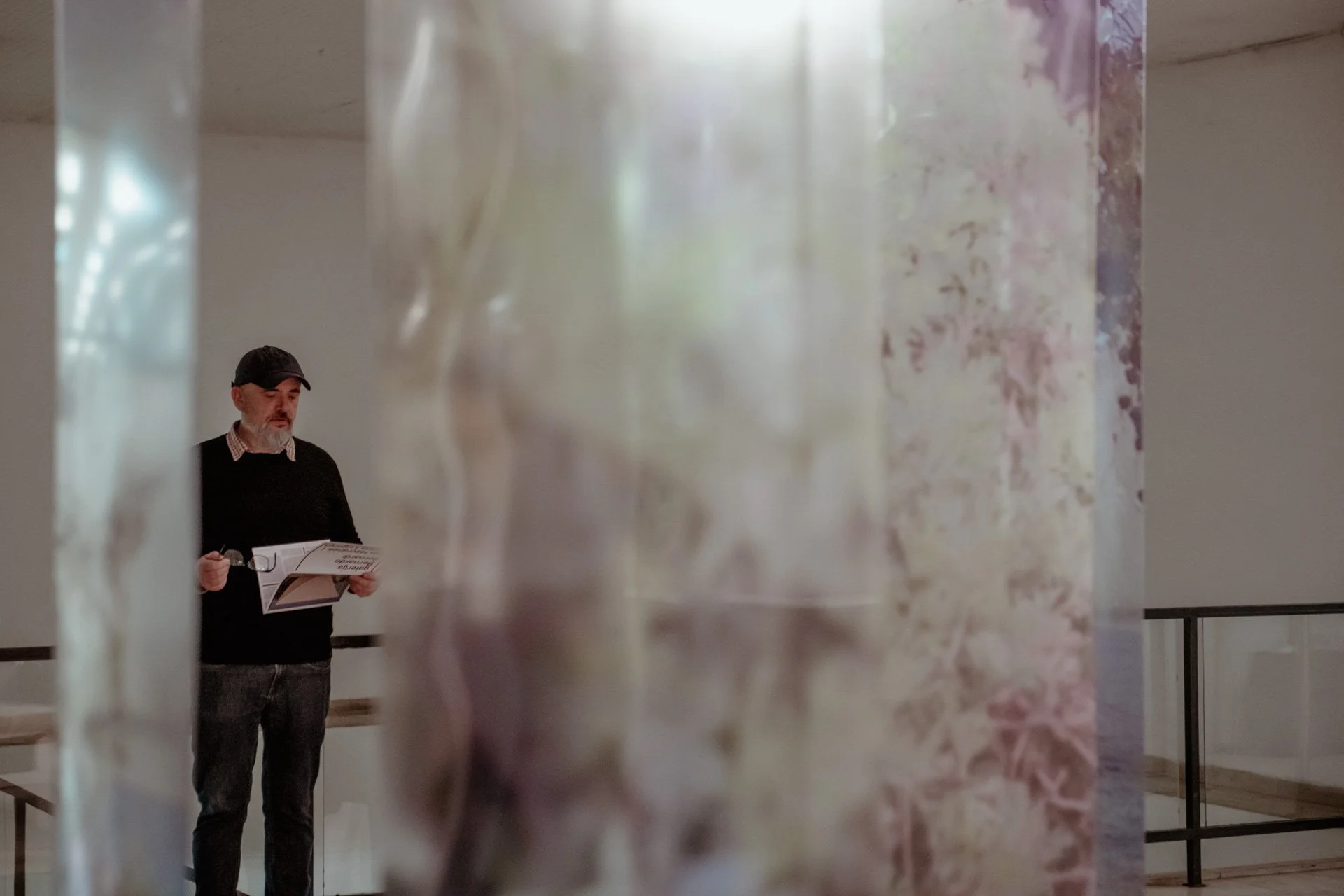  Inside the space, visitors encountered only a transparent fragment of each photograph, while the full image became visible when stepping back, creating a dynamic relationship between distance, perception, and context. The installation was completed 