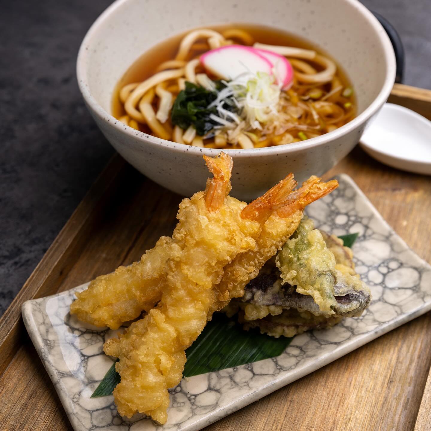 Slurp up some comfort with our Japanese Tempura Udon, served in a hot dashi broth with kamaboko and green onions. Choose your pairing: Vegetable Tempura for a light and crispy mix, Shrimp &amp; Veggie Tempura for a seafood twist, or Pork Belly &amp; 