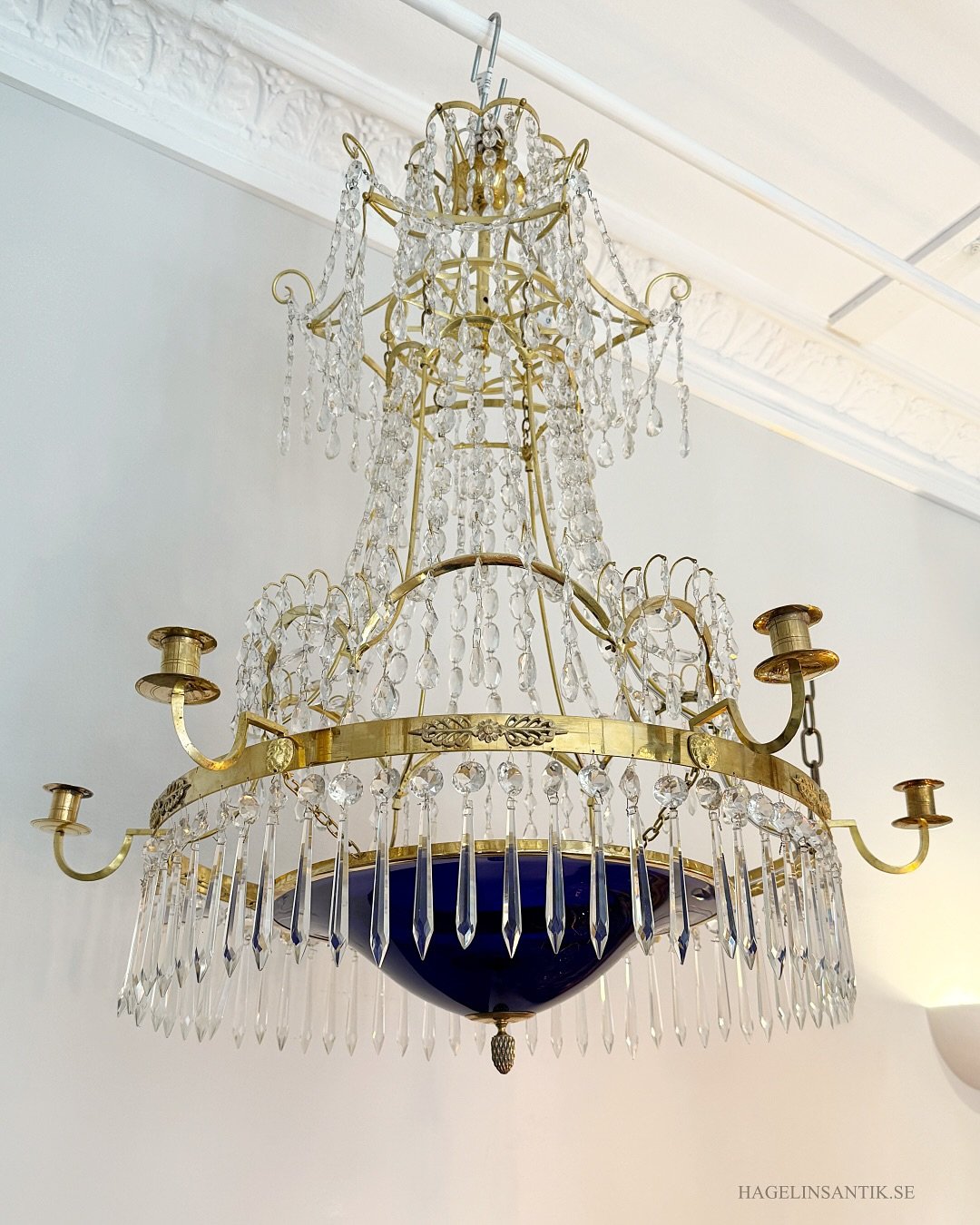 A beautiful chandelier in the late Gustavian style, crafted in Sweden in the late 19th or early 20th century. The chandelier features an intricate and highly decorative construction, with many charming and unusual details. It is adorned with Bohemian