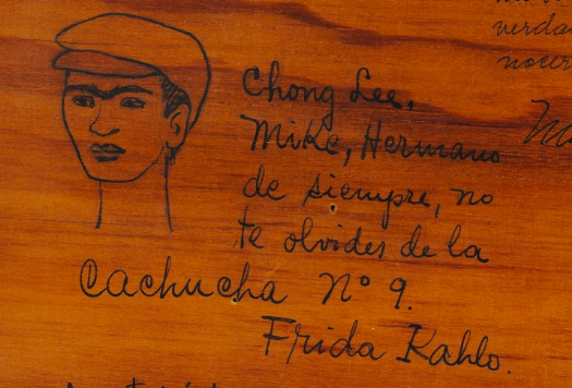 Close up of frida’s note to Miguel n. lira: “hermano de siempre no te olvides de la cahucha no 9, Frida Kahlo”— “Forever brother, do not forget la Cachucha no. 9, Frida Kahlo.” Alongside it is her doodle of herself wearing the cap for which the group was named, 1948.