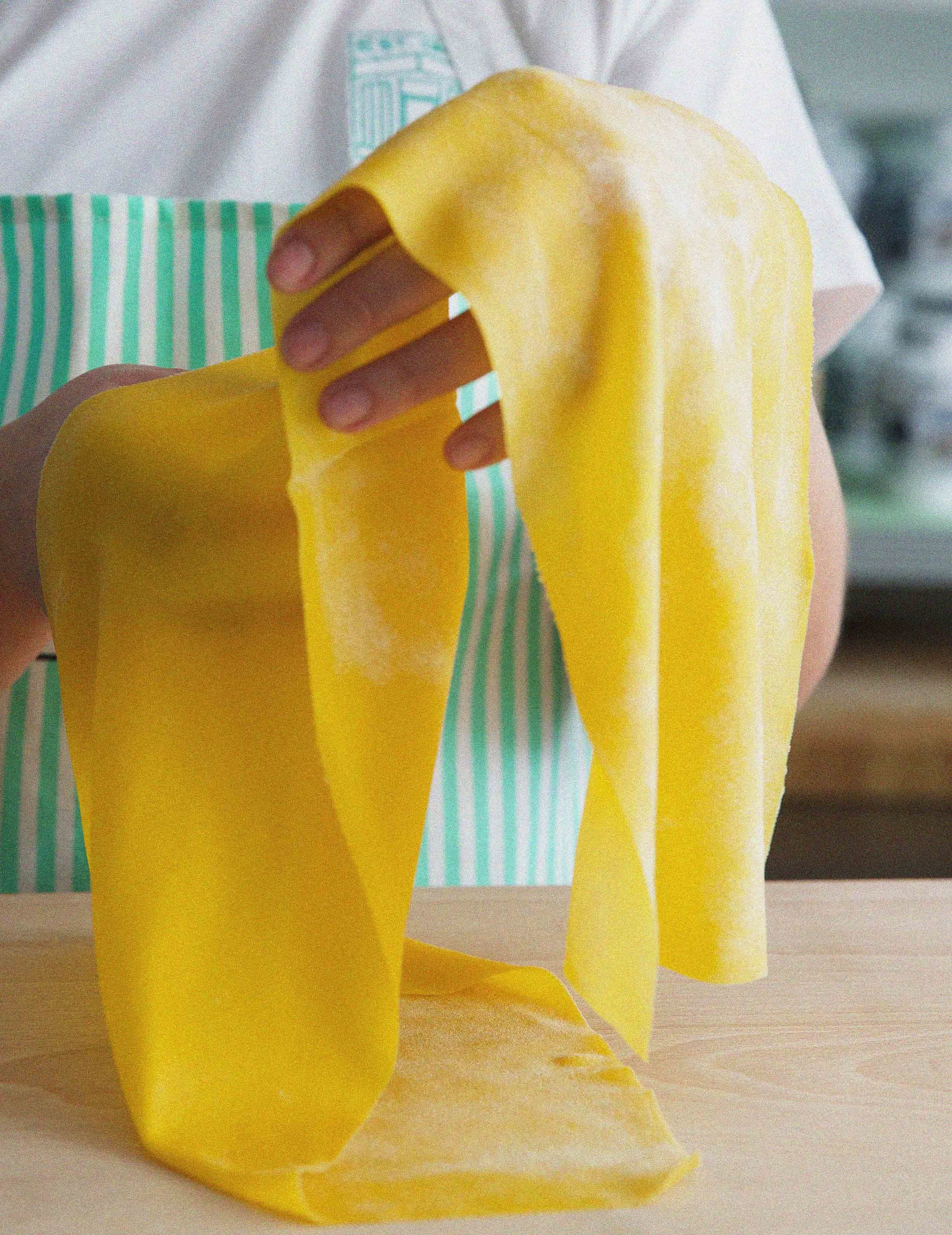 Pasta sheets being turned before rolling and slicing into pappardelle
