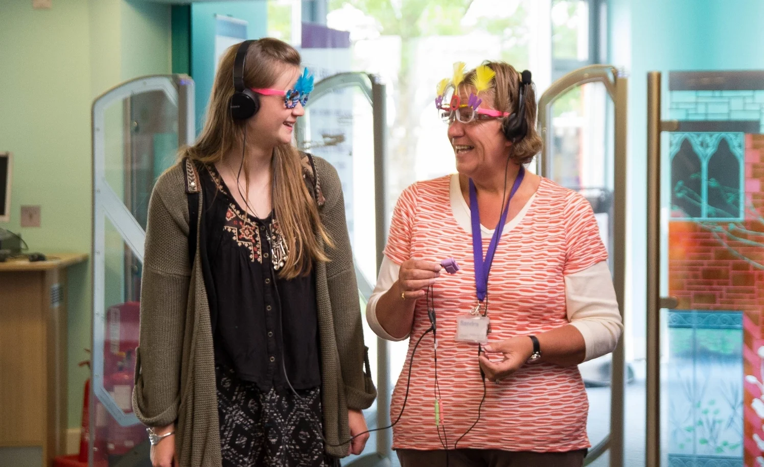 Two audience members take an audio tour of the library