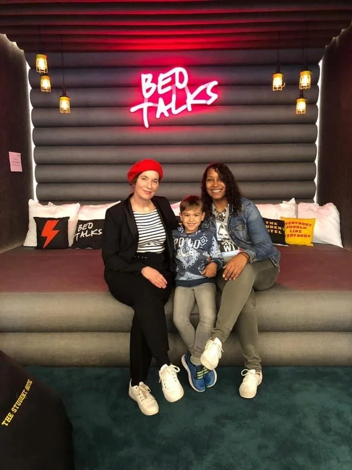 Shea sitting her son and Nathalie Hennequin before a Women in Tech Regatta event