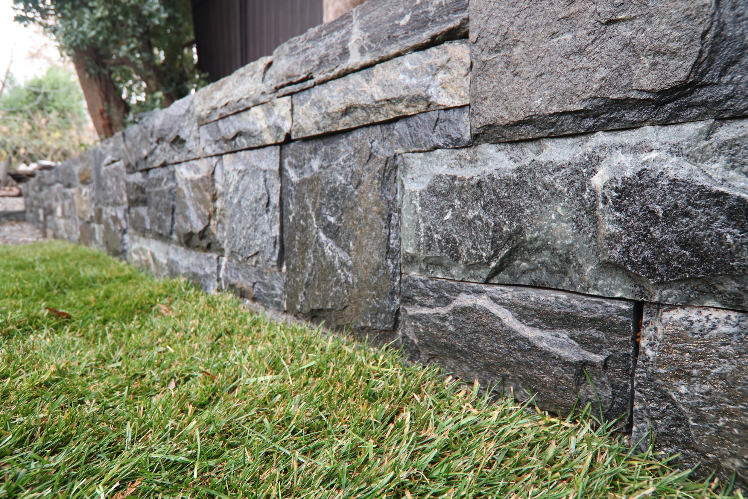 Hand Tooled Granite Wall Matches the Residence Foundation Veneer