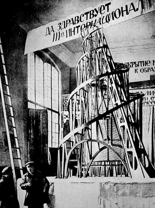 Creative Commons_Vladimir Tatlin and a model of his Monument to the Third International, Moscow, 1920.png