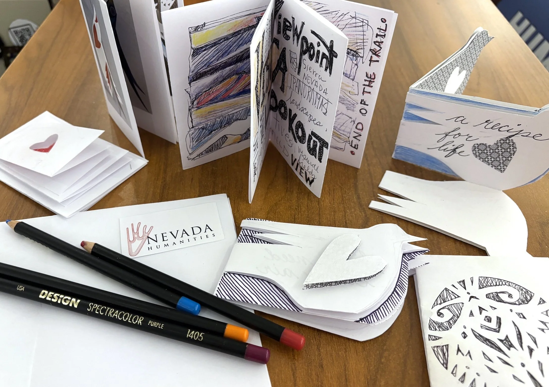 Zine-making materials on a table.