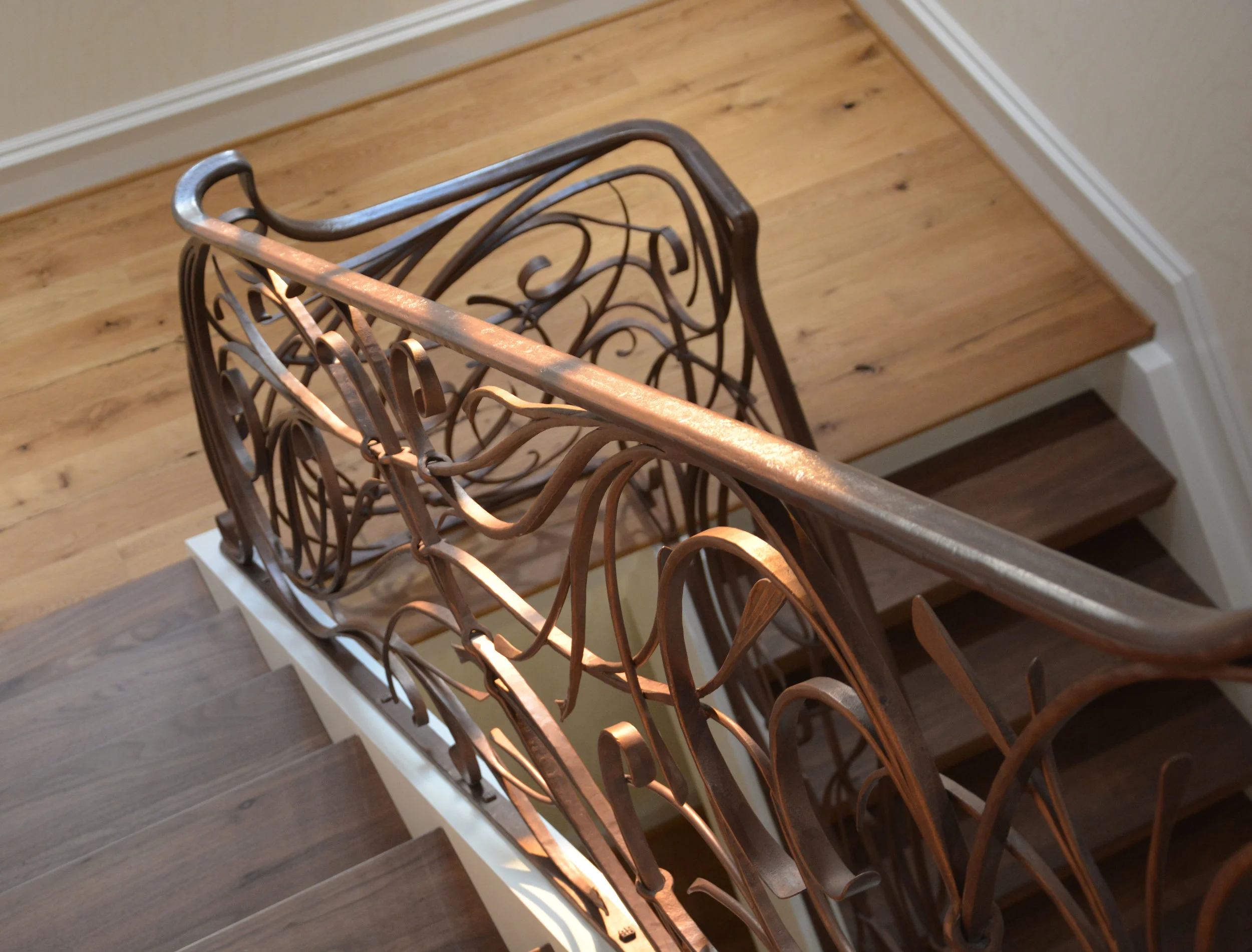 Here you can see the custom bronze patina that we finished this project with. Using a 3 part custom blend of waxes, we were able to create a one of a kind finish to suit our customers, and the interior designers color palette. This also facilitated a seamless finish as we were able to match the color perfectly at the splice joints. Given the fact that the project cascaded down 3 floors of the home we had to install the railing in 4 sections. Matching the color perfectly was an important part of the installation and the final product.