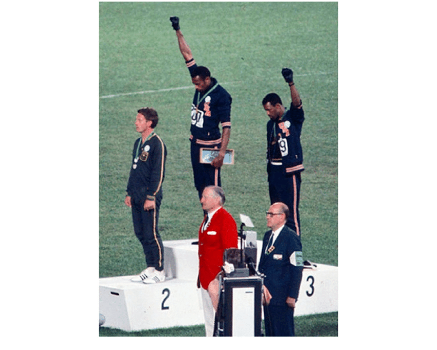 Angelo-Cozzi-Tommie-Smith-and-John-Carlos-at-the-1968-Mexican-Olympic-Games.png