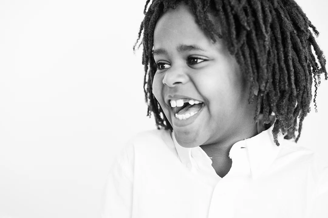 black and white photo of laughing boy