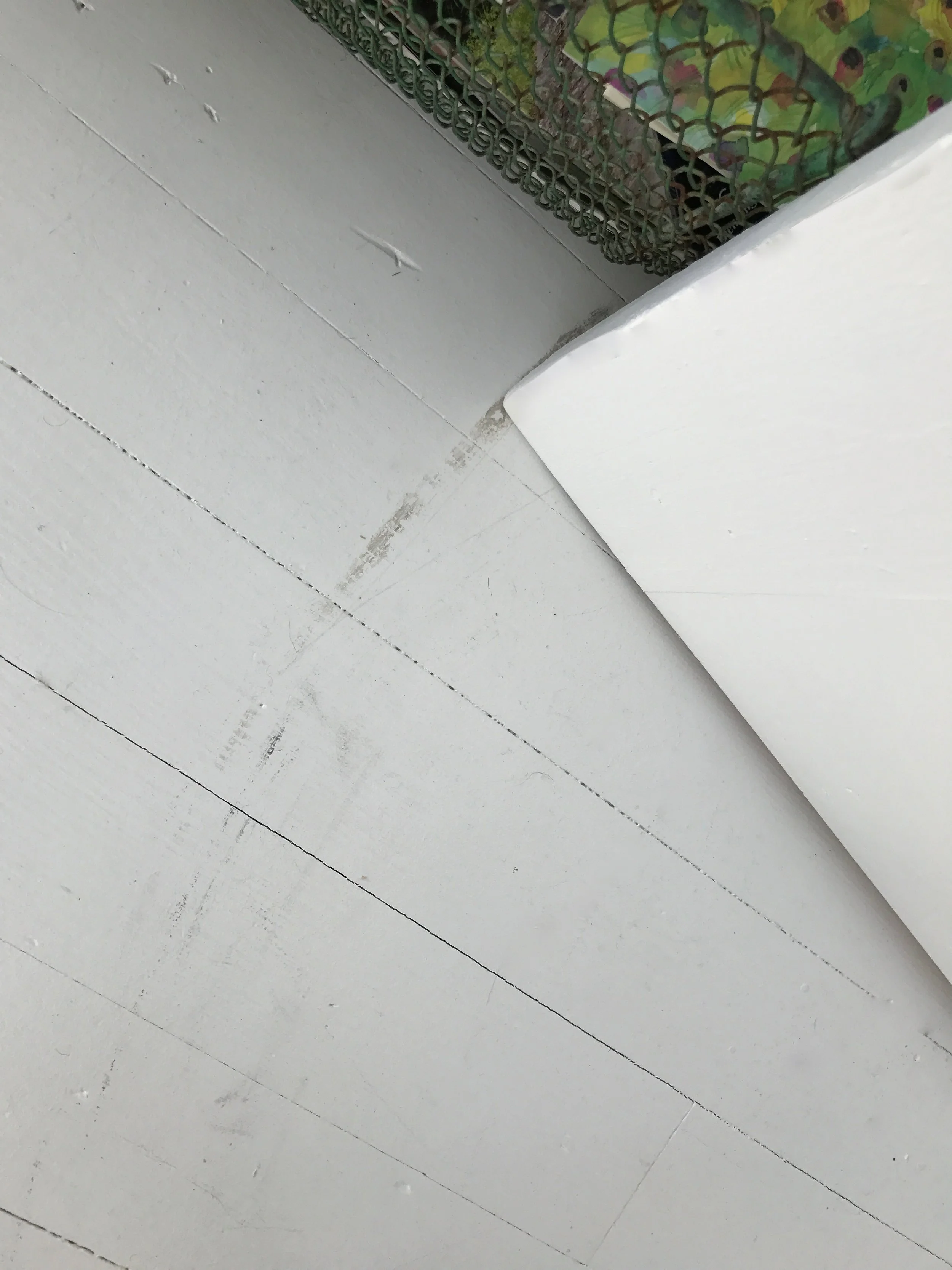 Marks from door scraping on painted floors