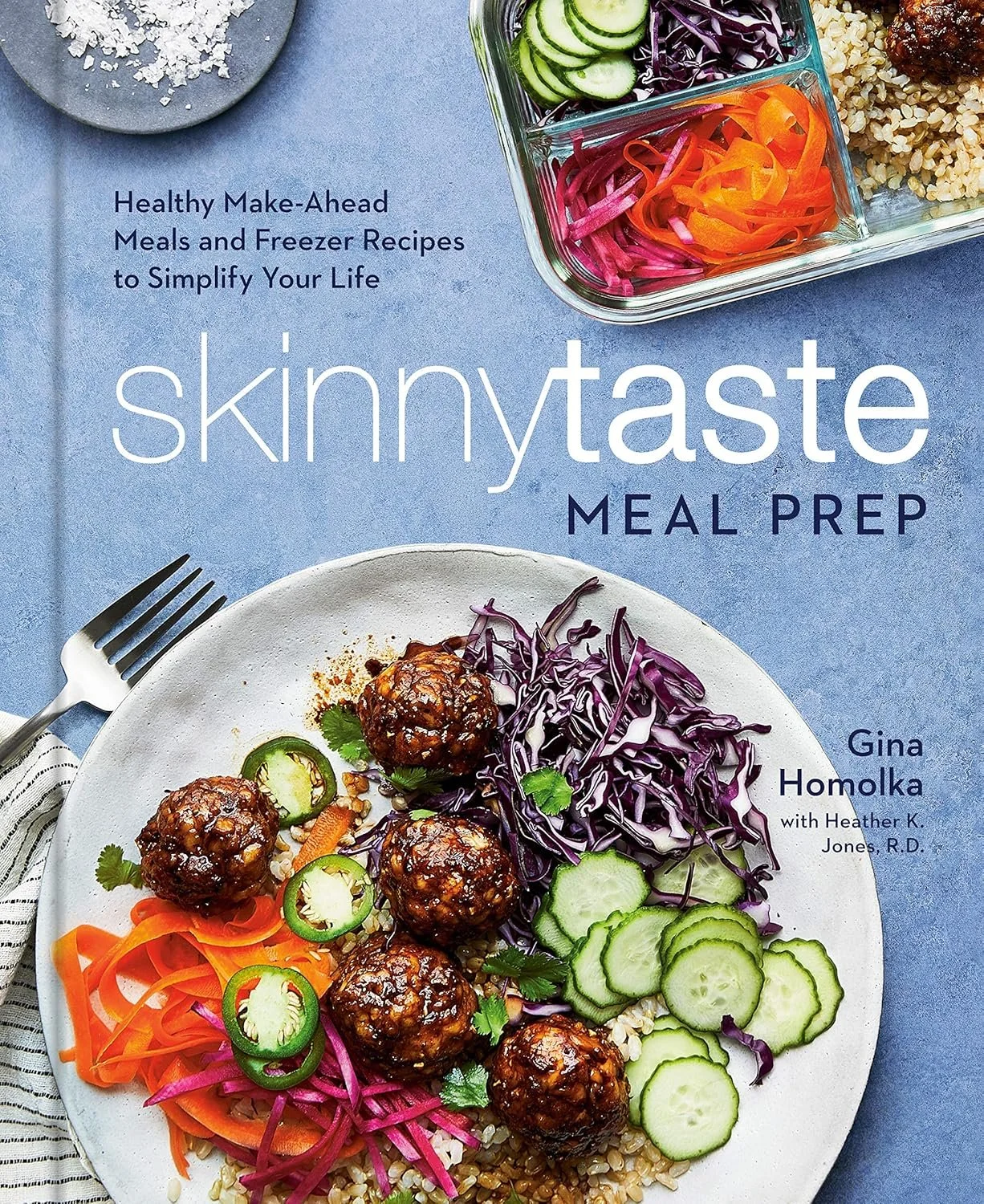 A magazine cover titled "skinnytaste meal prep" showing a plate with meatballs, sliced cucumbers, shredded purple cabbage, shredded carrots, pickled red onions, and rice, with a glass of sliced cucumbers and shredded carrots in a clear container in the background.
