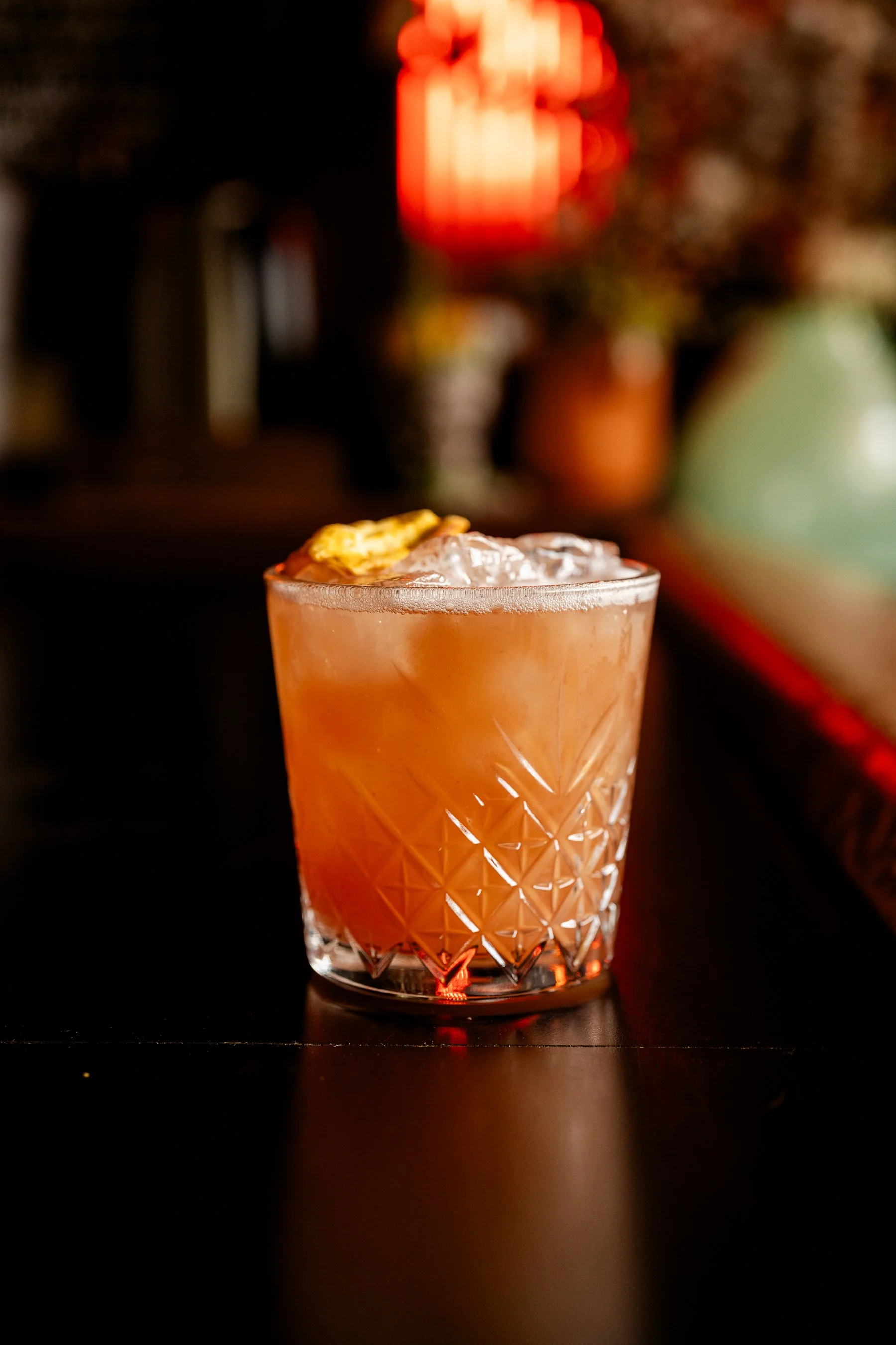 A craft cocktail in a textured glass at the cozy bar inside ludlow liquors