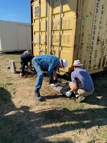 Getting the supporting blocks in place and leveling the containers.