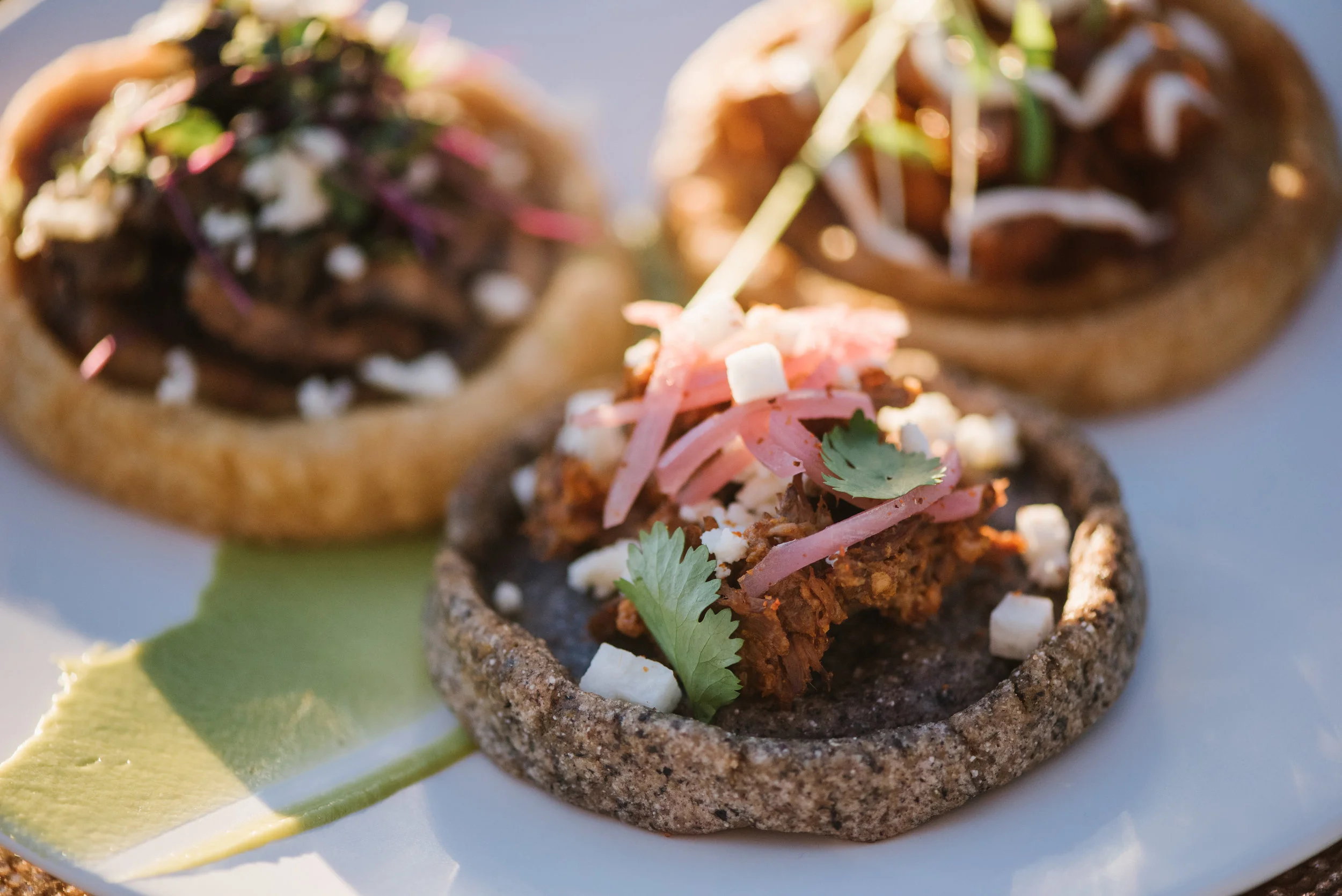 Sopes! Beef Barbacoa, queso fresco, jicama, tajin, pickled red onions, cilantro leaves Chicken Mole, crema, epazote, young cilantro Huitaloche & Mushrooms, ranchero salsa, crema, queso fresca, young cilantro