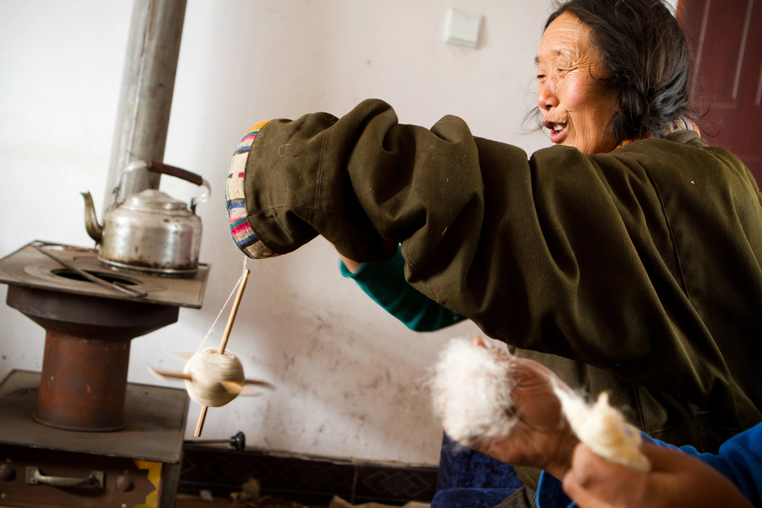 Women come together to comb and spin the yak wool. The soft wool will be made into garments and the tougher top coat will be spun to make the tents and ropes.