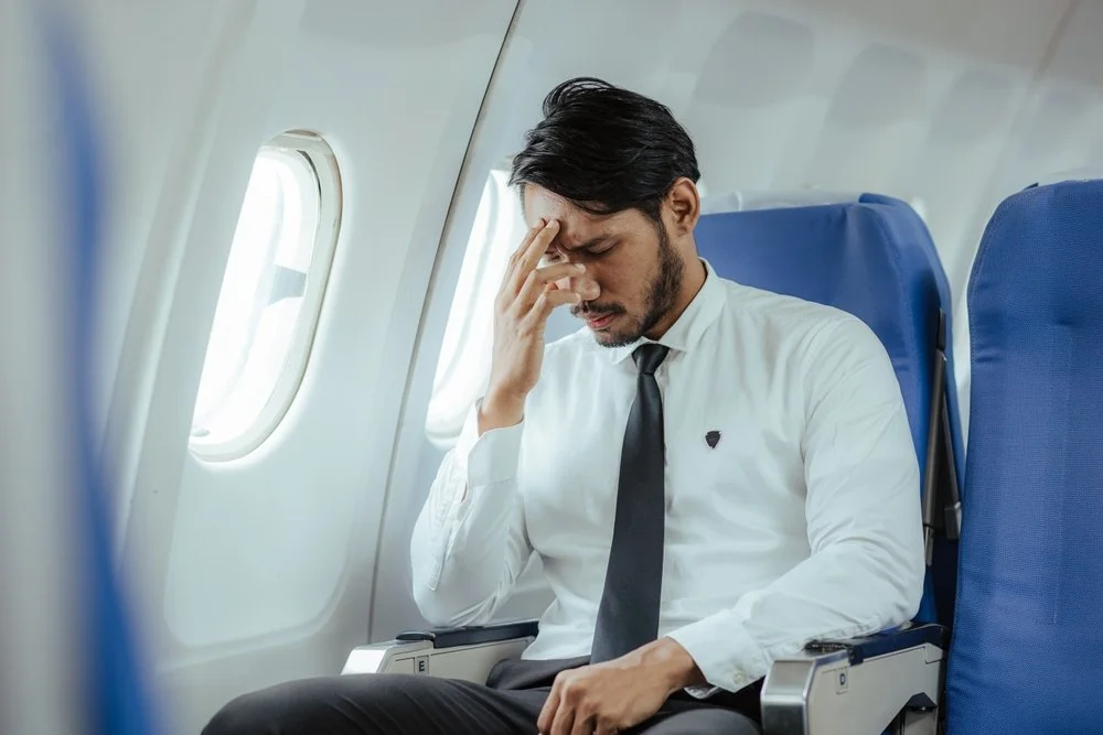 Man on a flight appearing to be afraid