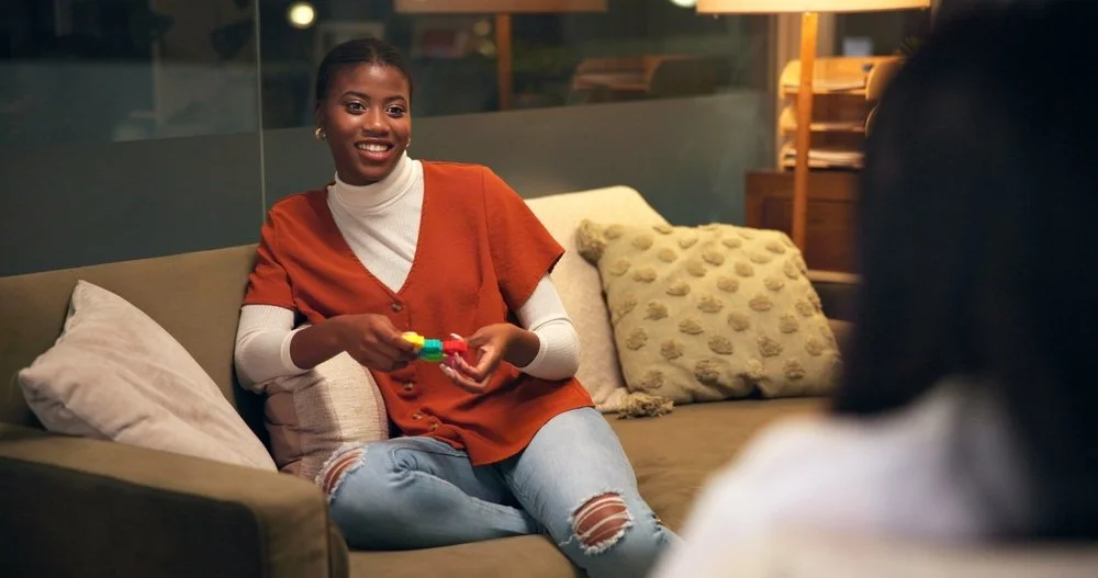 Woman, psychologist and fidget in office for therapy, social development and healing ADHD