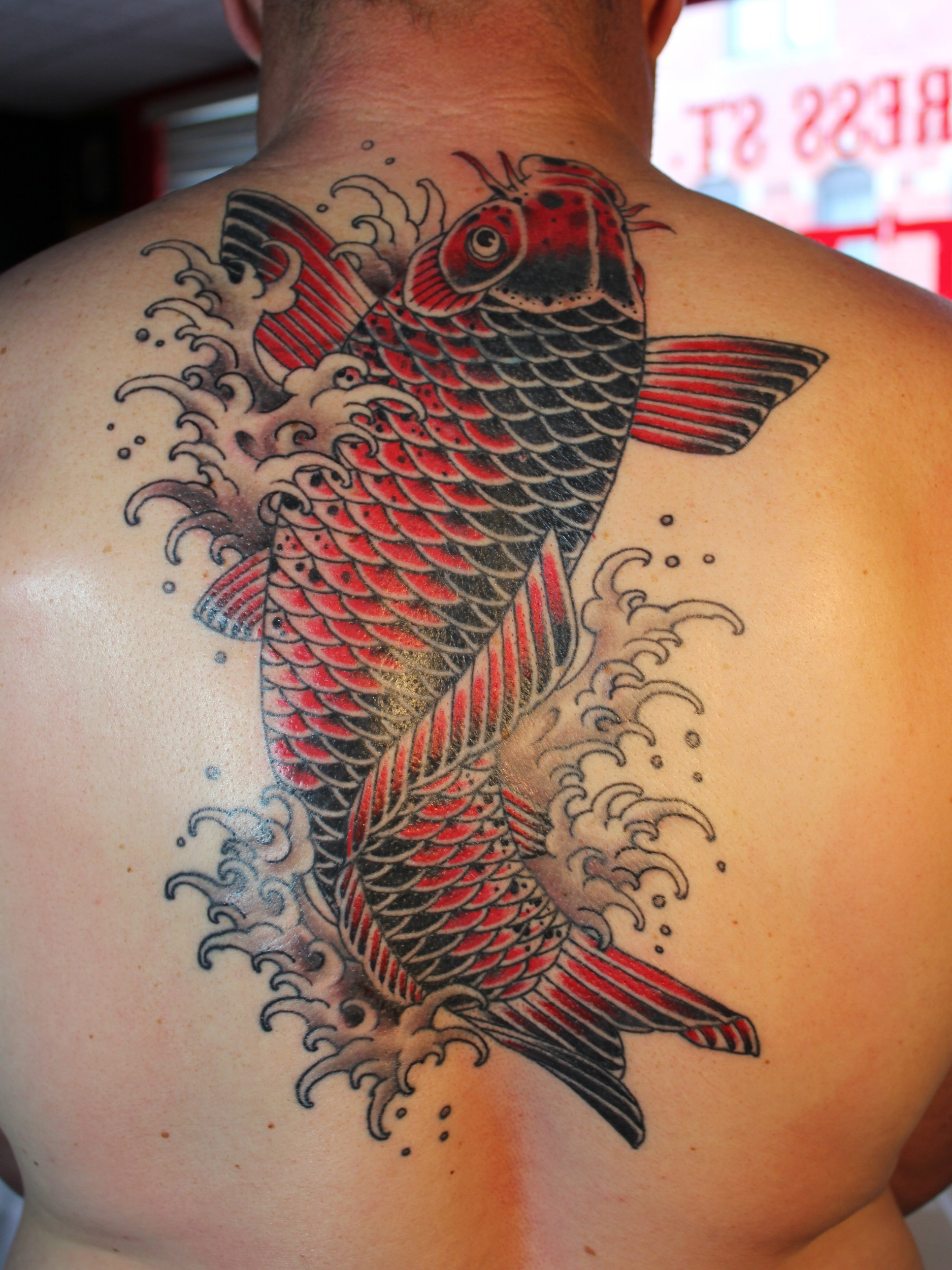 RED AND BLACK KOI FISH TATTOO ON BACK