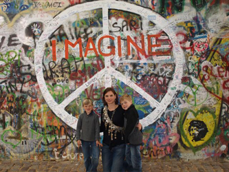 Pictured in front of the famous John Lennon Peace Wall, Prague