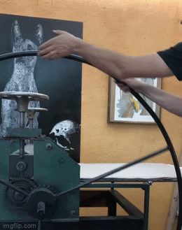 This is me at the printmaking press.  Working the wheel.