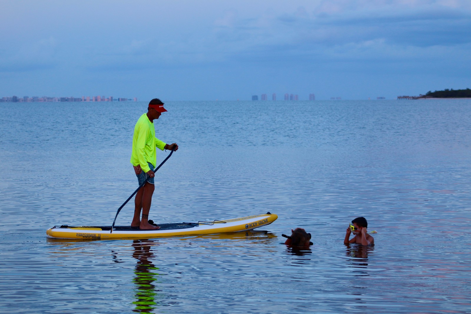 Dr. Bruce Neill supervises snorkelers via stand up paddleboard in San Carlos Bay. 