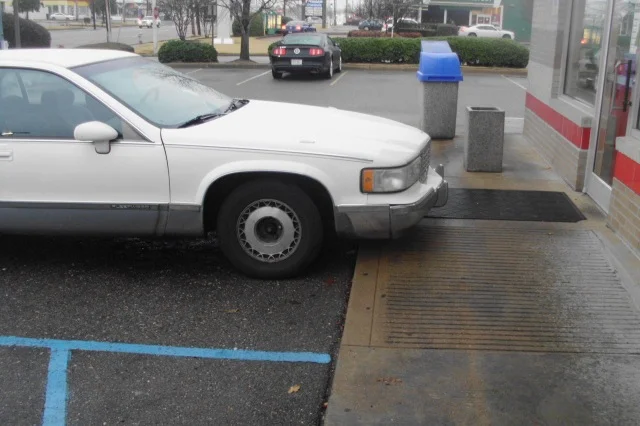 Car parked incorrectly in handicapped parking space