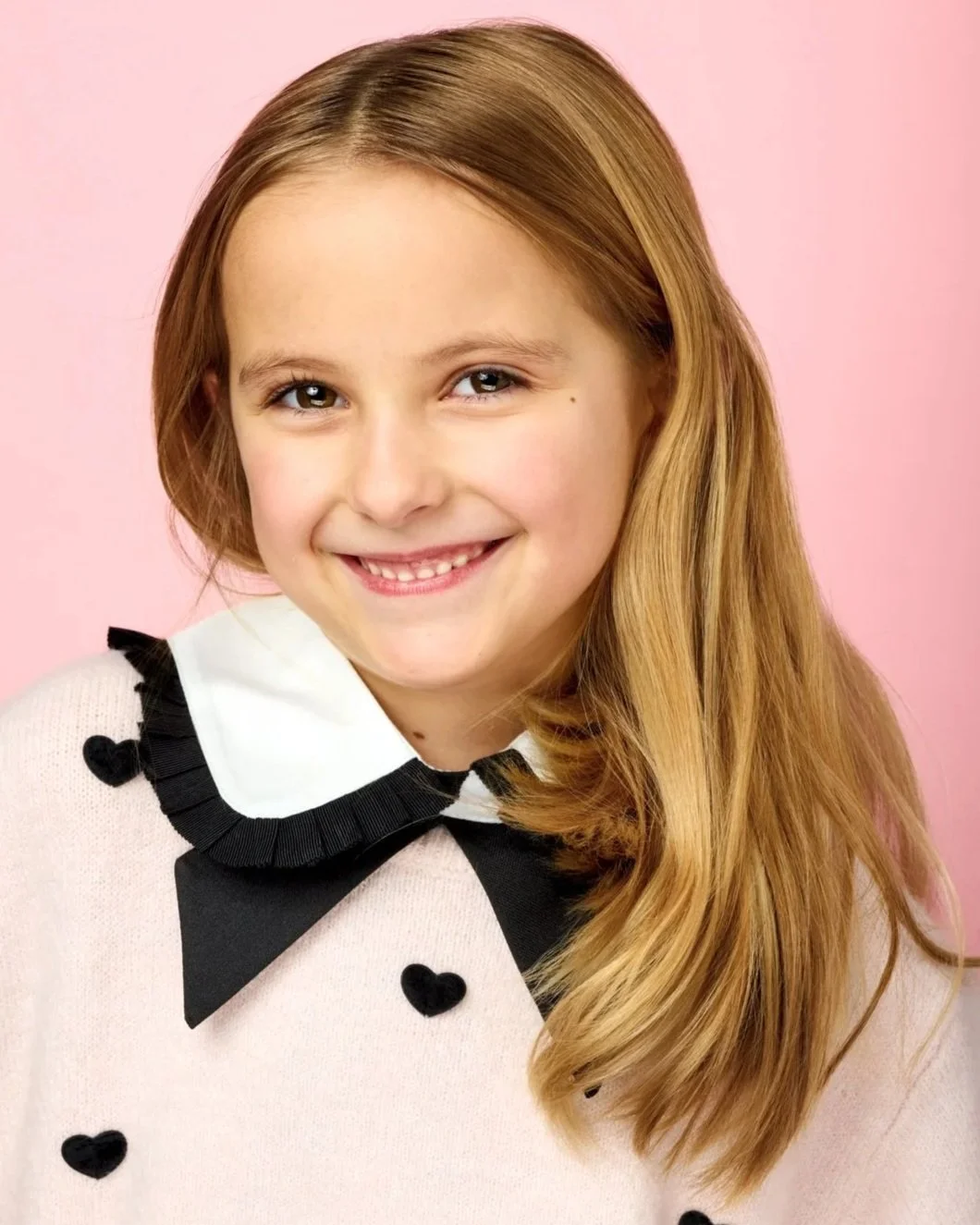 A natural and playful theatrical headshot of a young girl for her acting portfolio, shot in a Toronto photography studio.