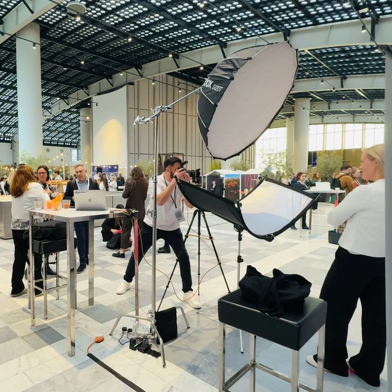 Binks Headshots mobile headshot studio setup at a large Toronto conference venue featuring professional lighting, backdrop, and on-site photography station.