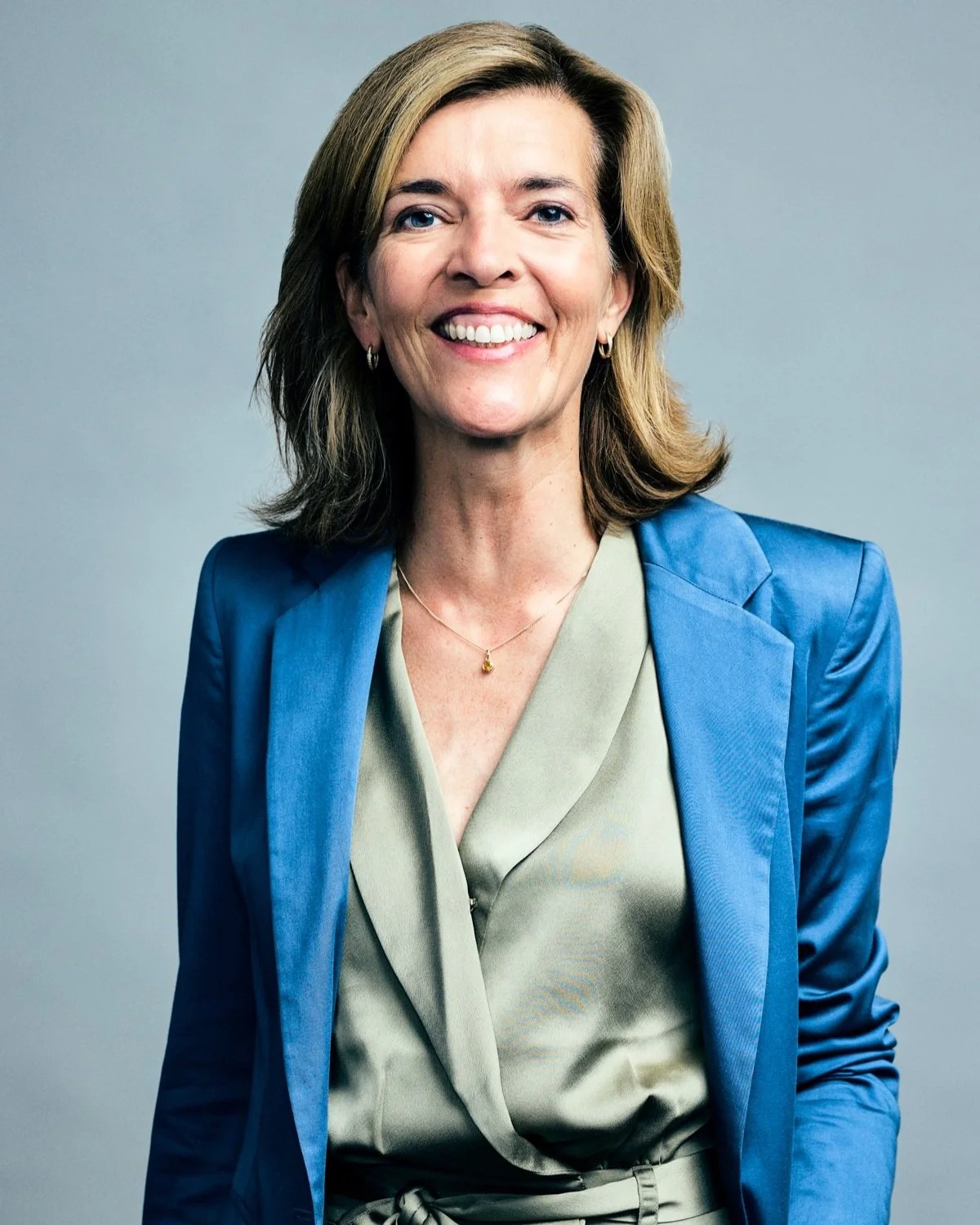 Professional linkedin headshot in a blue jacket taken at our Toronto studio.